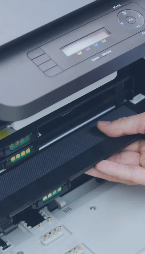 Hand replacing a toner cartridge in a printer – Reliable office equipment maintenance and support